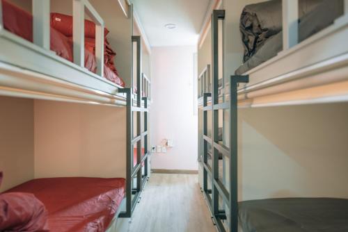 a room with four bunk beds and a bed at Daegu Midtown Hostel in Daegu
