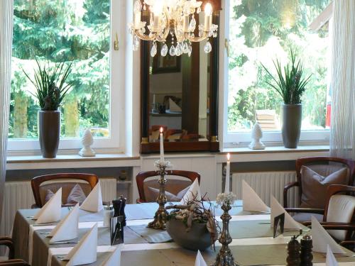 a dining room with a table and a mirror at Waldhotel "Peter aufm Berge" in Bielefeld