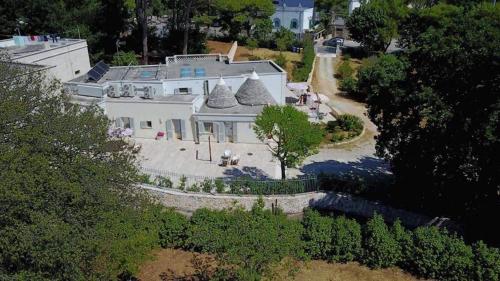 an aerial view of a white house with a tree at Villa Rosato in Selva di Fasano