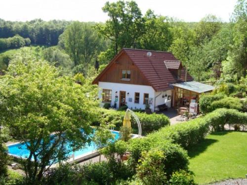 a house with a swimming pool in a yard at Holiday Home in Germany with Garden Terrace in Bredenborn