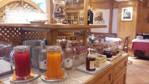 a table with many different types of drinks on it at Hotel Alpina in Pinzolo