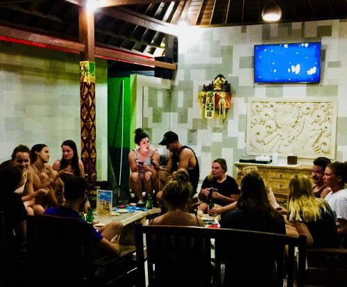 a group of people sitting in a room at Lembongan Hostel in Nusa Lembongan