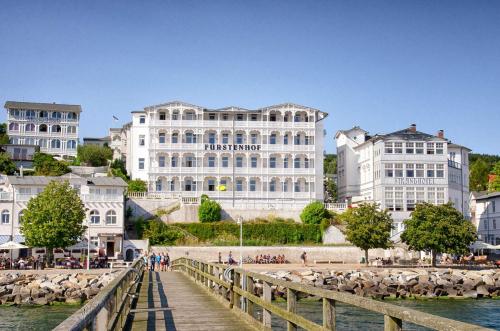 a group of buildings next to a river with a bridge at Fuerstenhof Appartement 401 in Sassnitz