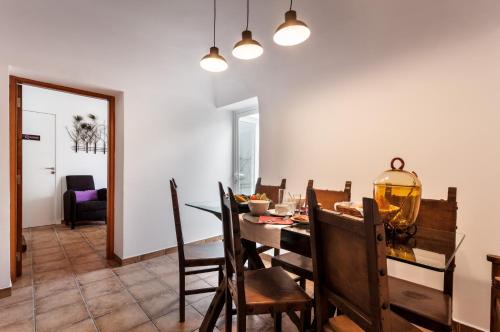a dining room with a table and chairs at Peacock House in Évora