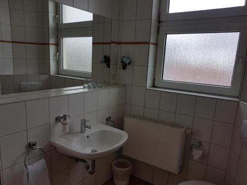 a bathroom with a sink and a mirror and a toilet at Mediterran in Hamburg