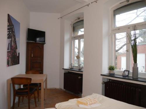 Habitación con mesa, cama y escritorio. en Alte Schmiede, en Ascheberg