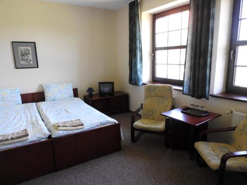 Ένα ή περισσότερα κρεβάτια σε δωμάτιο στο Noclegi u Eichendorffa