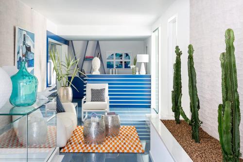 a living room with a glass table and cactus at Villa Aragonese Rooms in Monte di Procida