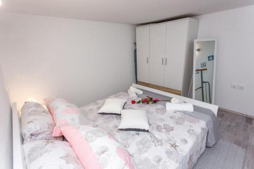a bedroom with a bed with flowers on it at Studio Apartment Vasilj in Split