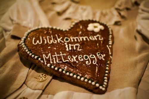 a heart shaped chocolate cake with writing on it at Hotel Gasthof Mitteregger in Kaprun