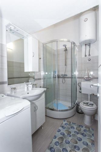 a bathroom with a shower and a sink and a toilet at Studio Apartment Vasilj in Split