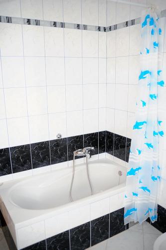 a bath tub with a faucet in a bathroom at Family house Branka in Peroj