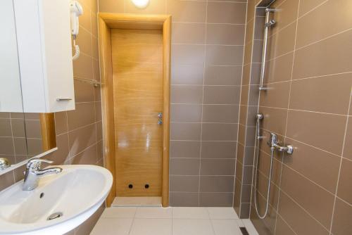 a bathroom with a sink and a shower at Residence Mahala in Sarajevo