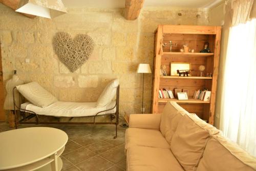 a living room with a couch and a table at Mas du Notaire in Gallician