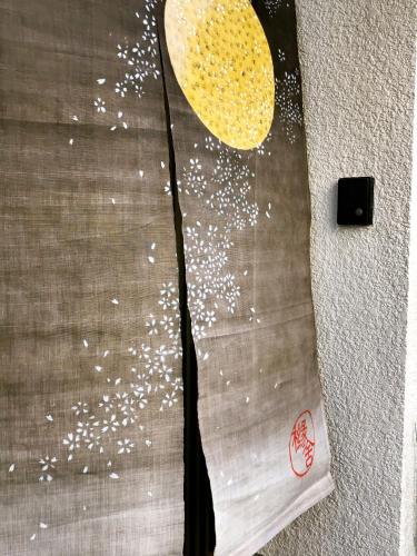 a bedsheet with a moon and white specks on it at Yuenshe Sanjusangendo Villa in Kyoto