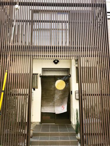 a front door of a house with a yellow umbrella on it at Yuenshe Sanjusangendo Villa in Kyoto