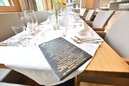 a table in a restaurant with a book on the table at Sporthotel Silvretta Montafon in Gaschurn