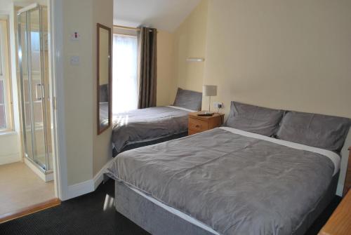 a hotel room with a bed and a window at Parkway Guesthouse in Dublin