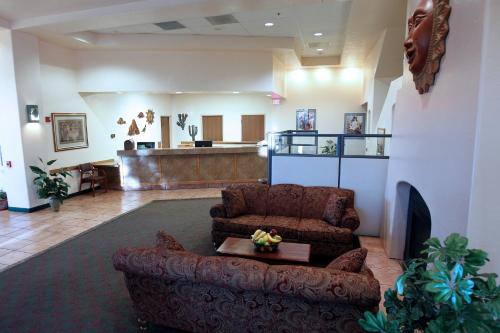 a living room with a couch and a table at Gateway Studio Suites in Sierra Vista