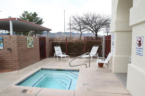 a patio with chairs and a swimming pool at Gateway Studio Suites in Sierra Vista