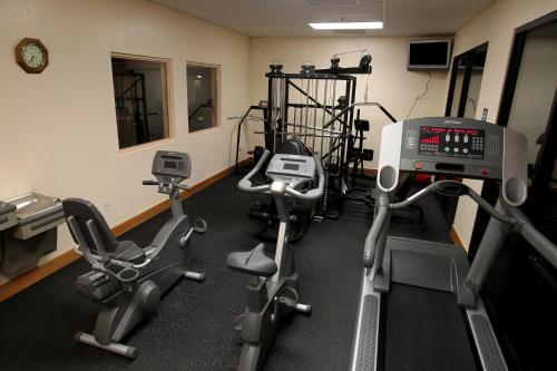 a gym with treadmills and exercise bikes in a room at Gateway Studio Suites in Sierra Vista