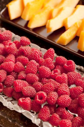 a pile of red raspberries and slices of cheese at Hotel Benn in Berlin