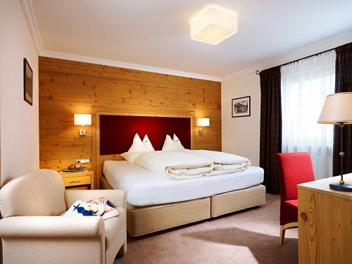 hotel & chalet madlochBlick في ليش ام ارلبرغ: غرفة فندقية بها سرير كبير وكرسي