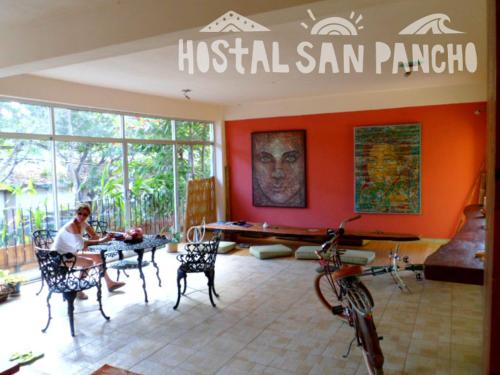a man sitting at a table in a room at Hostal San Pancho in San Francisco
