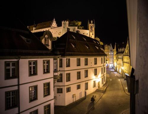 a view of a city at night with a castle at Altstadt-Loft Füssen in Füssen
