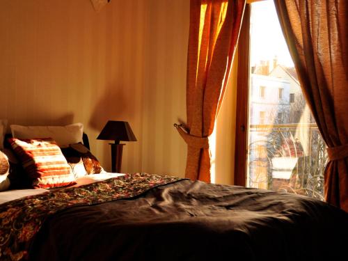a bedroom with a bed and a window with a view at SleepWalker Boutique Suites in Wrocław