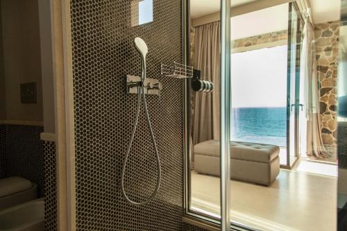 a bathroom with a shower with a view of the ocean at Ngonia Bay Boutique Hotel in Milazzo