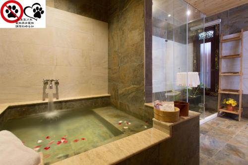 a bathroom with a jacuzzi tub with red peppers in it at Yue Ya Villa in Puli