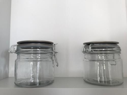 two glass jars sitting on top of a shelf at Lea am See - Bio Design Appartement in Tegernsee
