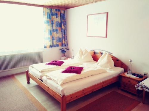 Un dormitorio con una cama con almohadas rojas. en Ferienwohnung Hobelleitner, en Sankt Blasen