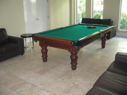 a pool table sitting in a living room with at The Atrium Resort in Grace Bay