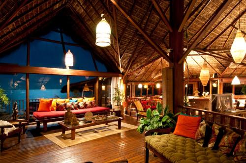a living room with couches and tables in a building at Hotel Sombra e Água Fresca in Pipa