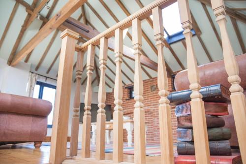 a staircase with wooden railings in a house at The Stables in Southwell in Southwell