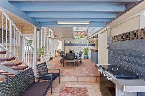 a balcony with a table and chairs in a building at Clifford Park Motor Inn in Toowoomba