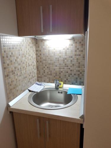 a bathroom sink with a light on top of it at Casa Rezidentiala Aria in Cluj-Napoca