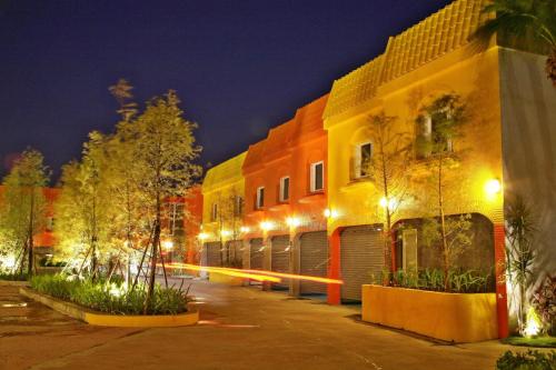 a row of buildings on a street at night at Chusha Motel in Gongguan