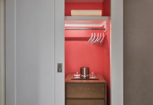 a kitchen with red walls and a cabinet with utensils at Flamingo Las Vegas Hotel & Casino in Las Vegas