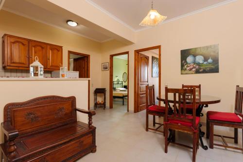 a kitchen and dining room with a table and chairs at Photographer's Apartments in Alikanas