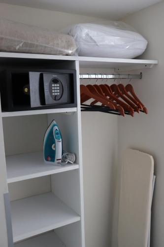a white closet with a shelf with a scale in it at Best Western Plus Metepec & Suites in Toluca