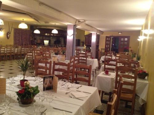 a dining room with white tables and chairs at Bel Air in Marville