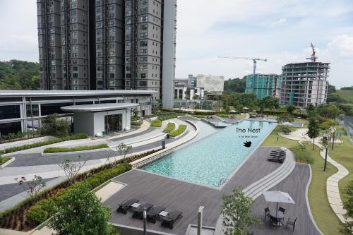 a swimming pool in a city with tall buildings at Cozy Hyve Soho Suites in Cyberjaya