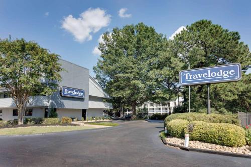 a sign that reads travelodge in front of a building at Travelodge by Wyndham College Park in Atlanta
