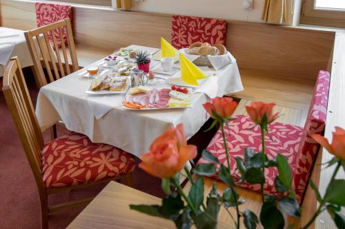 a table with food and plates of food on it at Hotel Reineldis in Mureck
