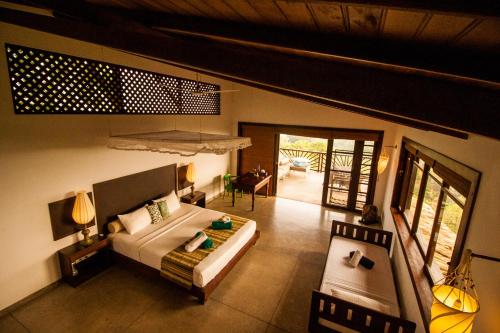 una camera con un letto e una sedia di Little Tamarind a Tangalle