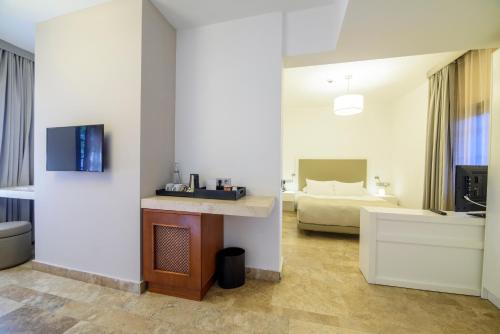 a hotel room with a bedroom with a bed at Yalikavak Marina Garden Hotel in Yalıkavak