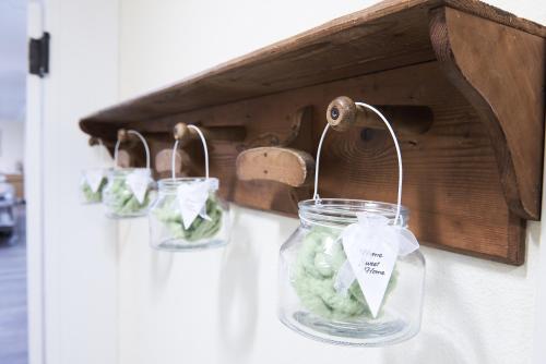 a group of jars of green vegetables in a wooden box at Hotel Miramonti in Schio